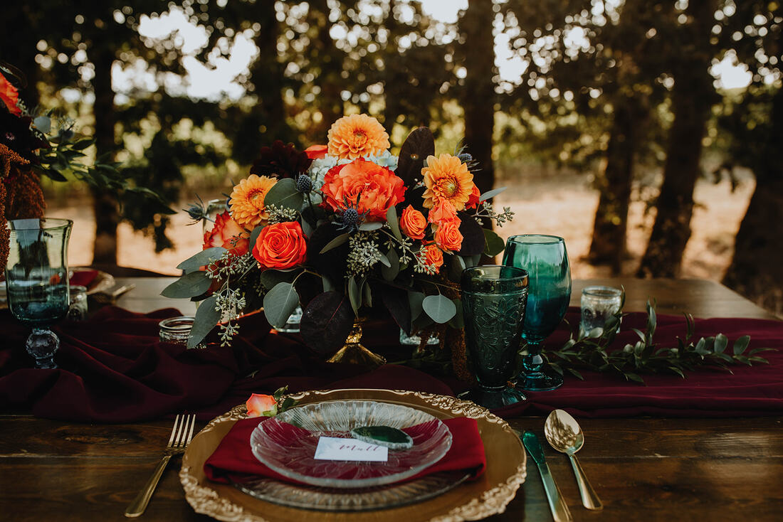 Table scape with and orange flower centerpiece